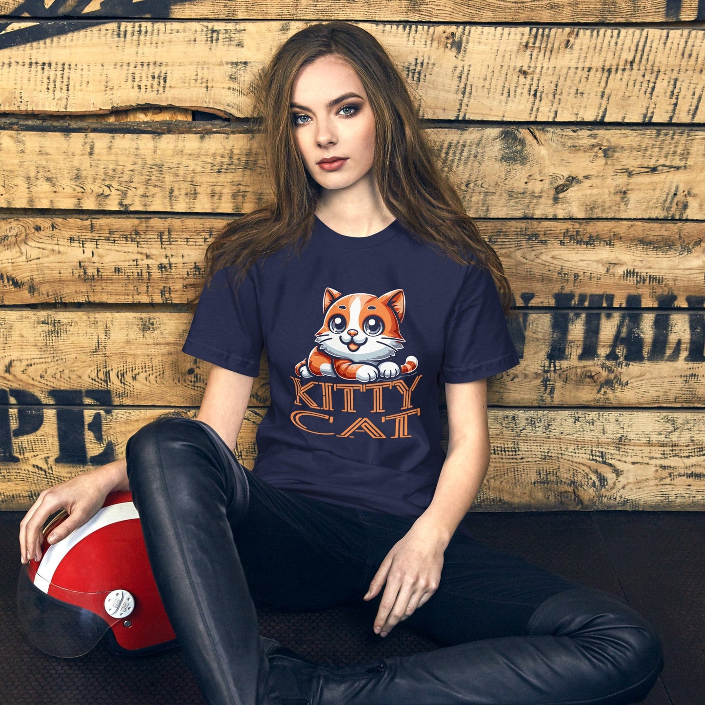 Woman wearing OMThread's 'Kitty Cat' t-shirt in navy blue, showing a charming cartoon orange tabby cat with bold orange text, a must-have for cat fans and casual style.