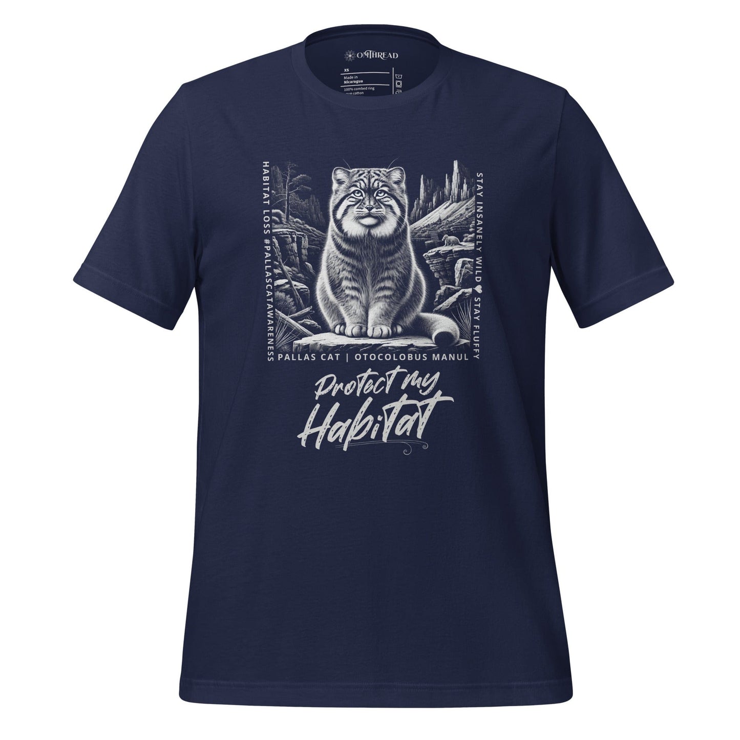 Navy blue t-shirt featuring a detailed black-and-white illustration of a Pallas cat sitting in its natural habitat, surrounded by mountains and rocks. Text reads 'Protect My Habitat' with additional phrases like 'Habitat Loss | Pallas Cat Awareness' and 'Stay Insanely Wild & Stay Fluffy'.