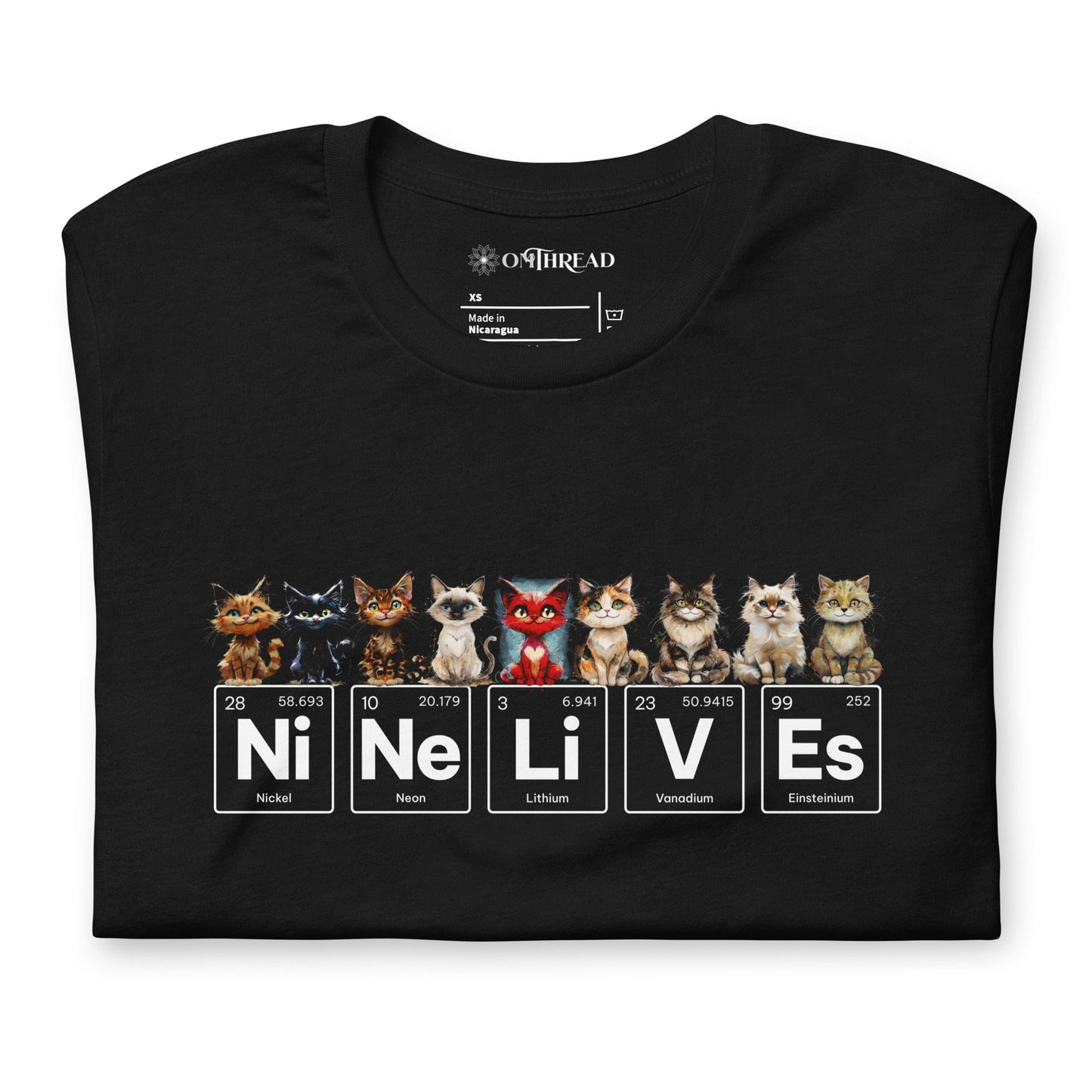 Black t-shirt featuring nine illustrated cats, each with a unique expression, sitting above periodic table elements that spell 'Ni Ne Li V Es' (Nickel, Neon, Lithium, Vanadium, and Einsteinium), representing 'Nine Lives.