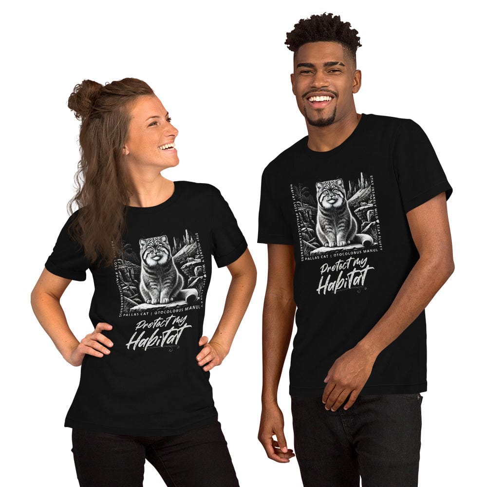 Woman and man wearing black t-shirt featuring a detailed black-and-white illustration of a Pallas cat sitting in its natural habitat, surrounded by mountains and rocks. Text reads 'Protect My Habitat' with additional phrases like 'Habitat Loss Pallas Cat Awareness' and 'Stay Insanely Wild & Stay Fluffy'.