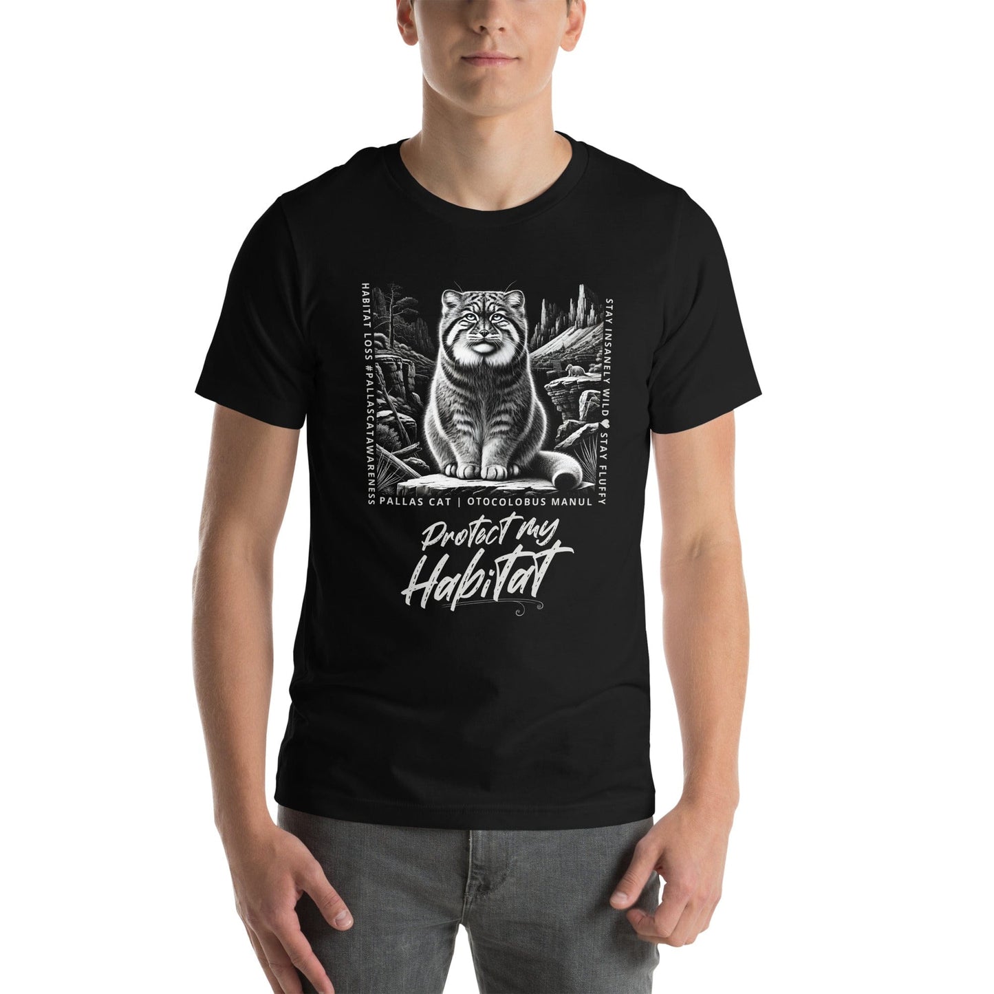 Man wearing black t-shirt featuring a detailed black-and-white illustration of a Pallas cat sitting in its natural habitat, surrounded by mountains and rocks. Text reads 'Protect My Habitat' with additional phrases like 'Habitat Loss Pallas Cat Awareness' and 'Stay Insanely Wild & Stay Fluffy'.