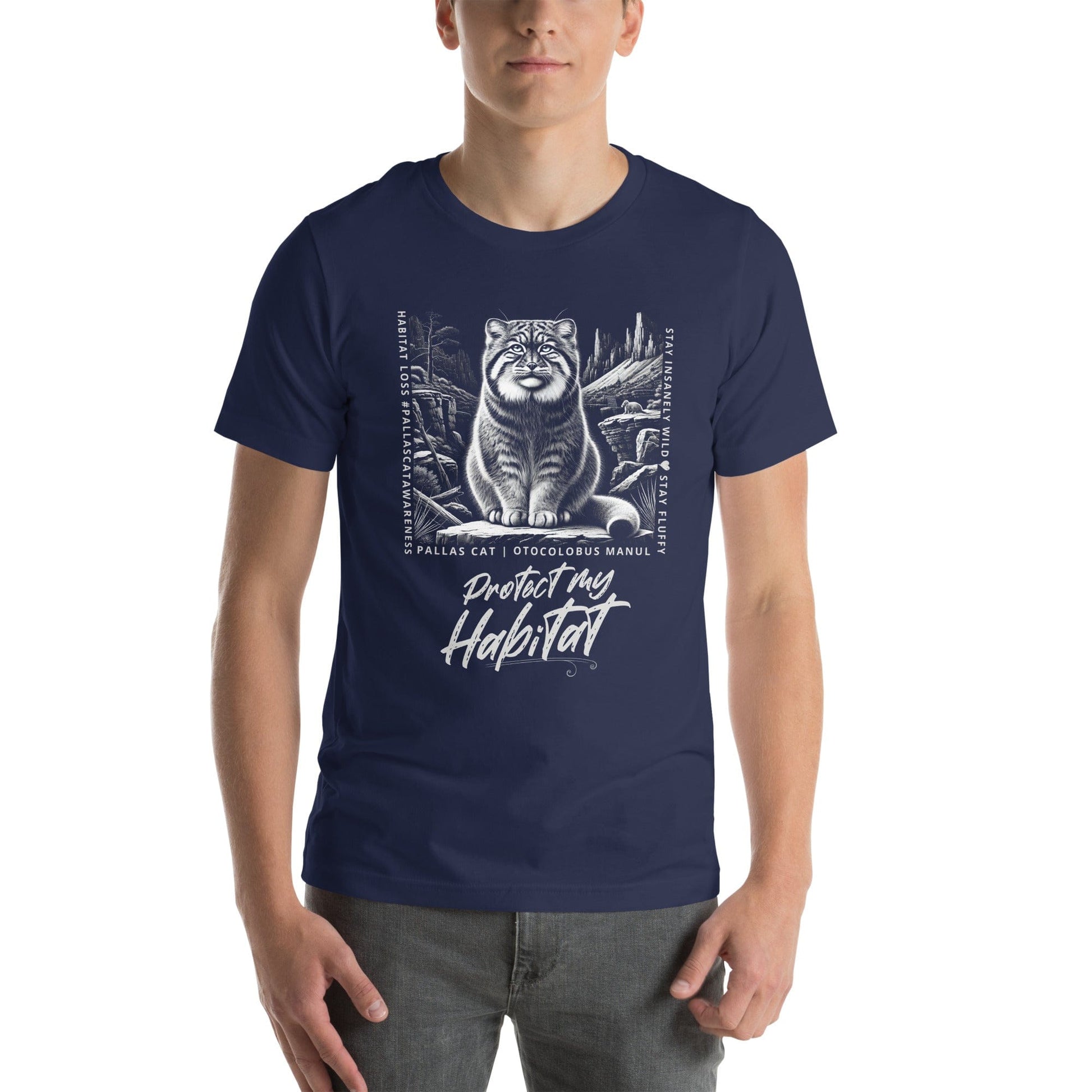 Man wearing navy blue t-shirt featuring a detailed black-and-white illustration of a Pallas cat sitting in its natural habitat, surrounded by mountains and rocks. Text reads 'Protect My Habitat' with additional phrases like 'Habitat Loss | Pallas Cat Awareness' and 'Stay Insanely Wild & Stay Fluffy'.