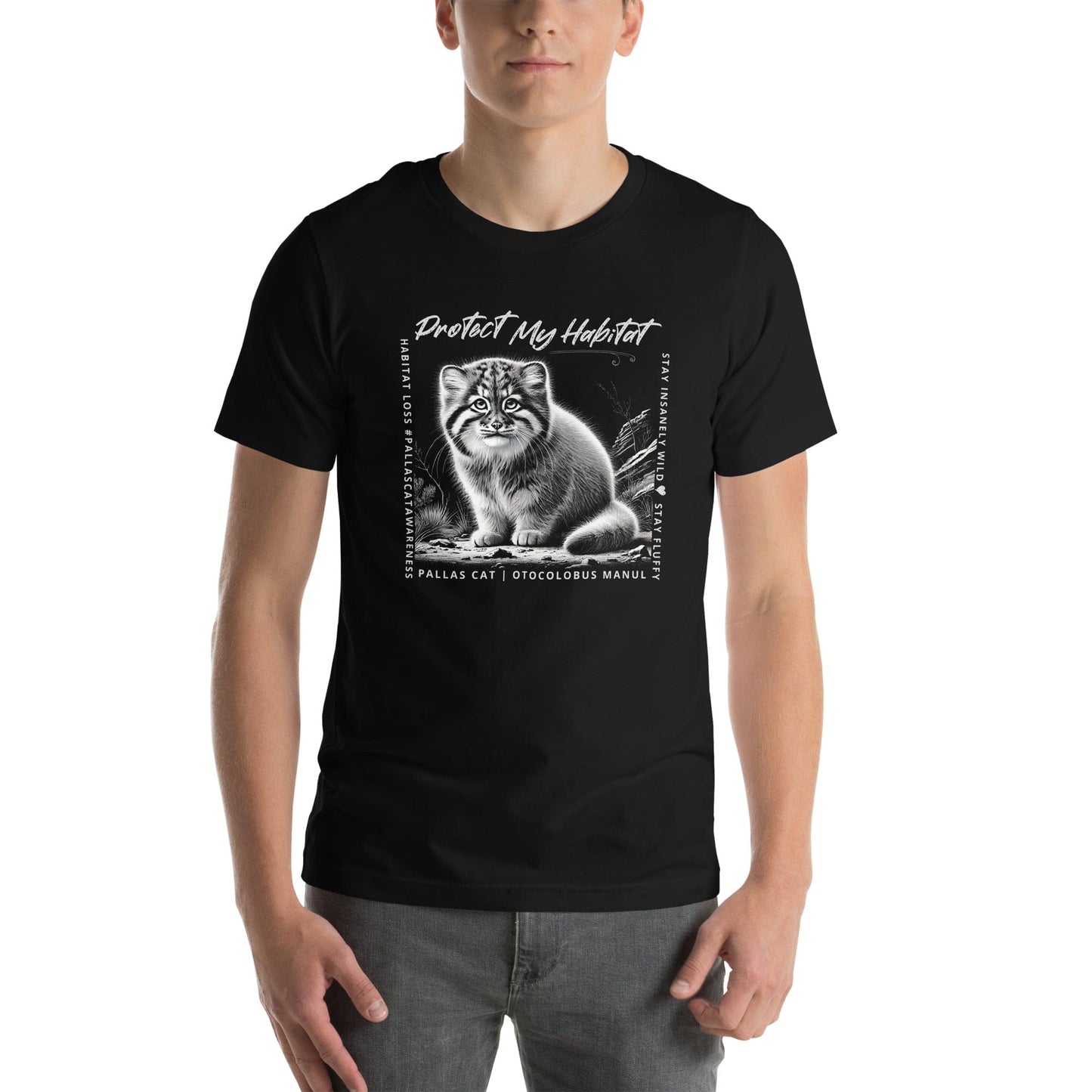 Man wearing black t-shirt featuring a detailed black-and-white illustration of a Pallas Kitten sitting in its habitat. The design includes the phrase 'Protect My Habitat' at the top, with text on the sides reading 'Habitat Loss Pallas Cat Awareness' and 'Stay Insanely Wild & Stay Fluffy'. The bottom features 'Pallas Cat Otocolobus Manul' in clean typography