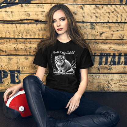 Woman wearing Black t-shirt featuring a detailed black-and-white illustration of a Pallas Kitten sitting in its habitat. The design includes the phrase 'Protect My Habitat' at the top, with text on the sides reading 'Habitat Loss Pallas Cat Awareness' and 'Stay Insanely Wild & Stay Fluffy'. The bottom features 'Pallas Cat Otocolobus Manul' in clean typography