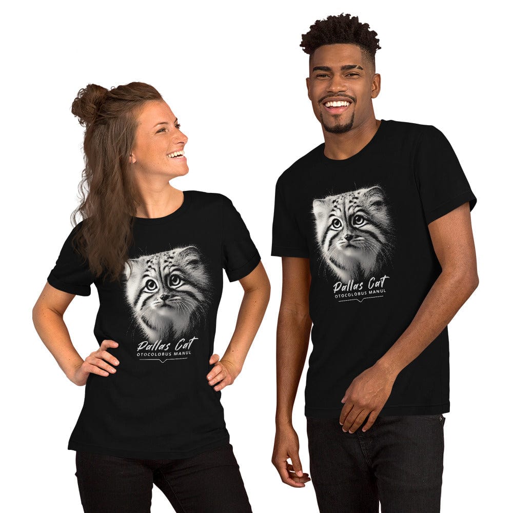 Woman and man wearing black t-shirt featuring a close-up, black-and-white illustration of a Pallas kitten's face with striking fur details and intense eyes. Below the image, 'Pallas Cat' is written in elegant white script, followed by 'Otocolobus Manul' in smaller capital letters.