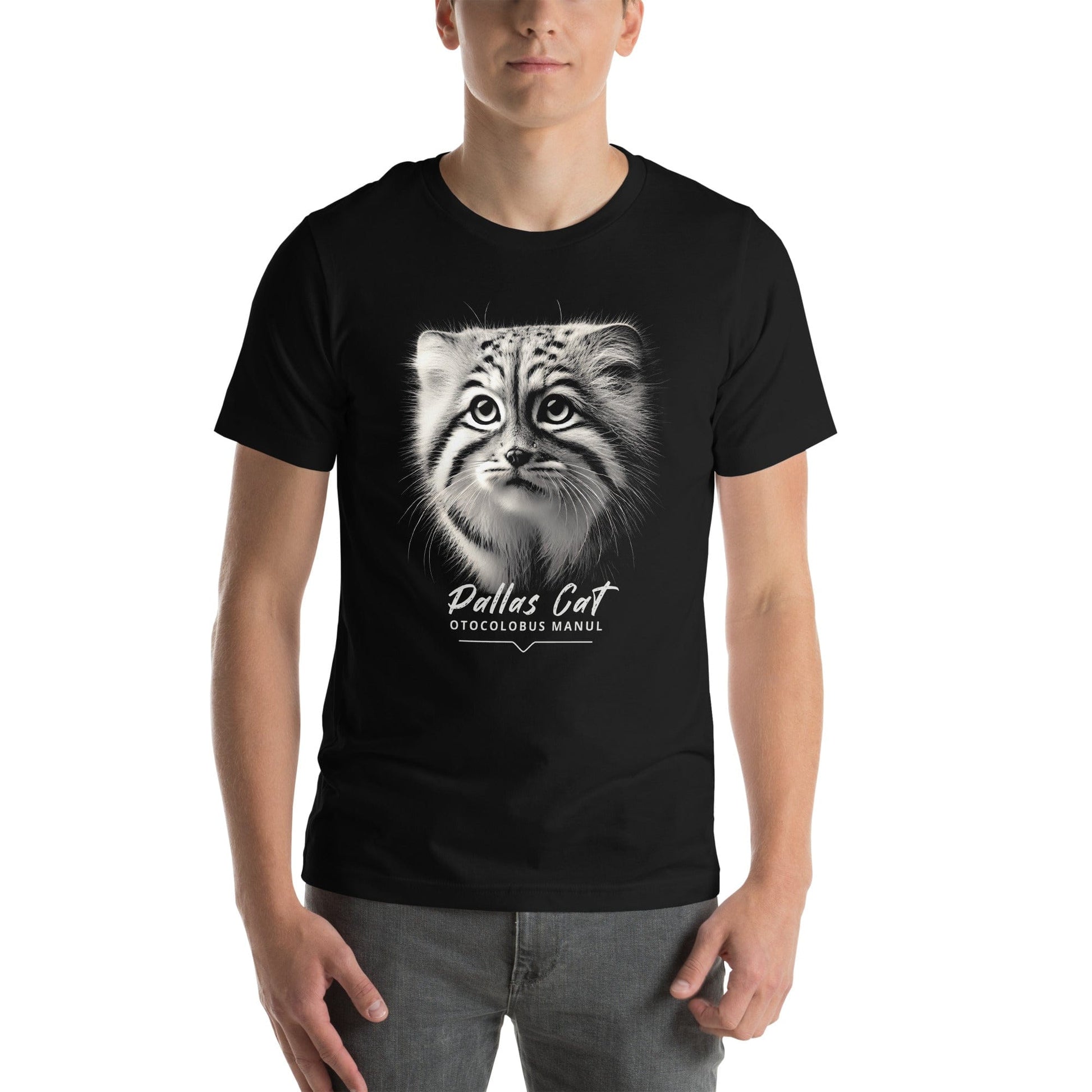 Man wearing black t-shirt featuring a close-up, black-and-white illustration of a Pallas kitten's face with striking fur details and intense eyes. Below the image, 'Pallas Cat' is written in elegant white script, followed by 'Otocolobus Manul' in smaller capital letters.