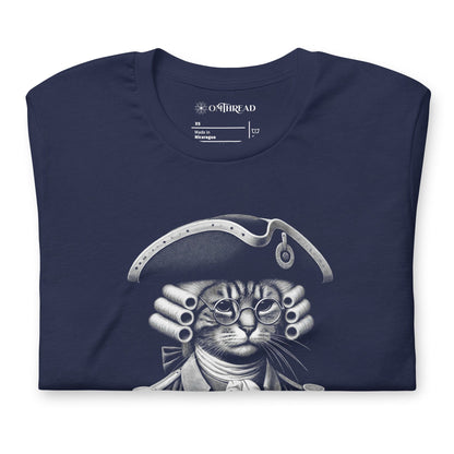 Navy blue t-shirt featuring a humorous design of a cat dressed as a founding father in colonial attire, complete with a tricorne hat and glasses. The text, Pawsuit of Happiness is displayed below in bold, styled with stars and a decorative arch.