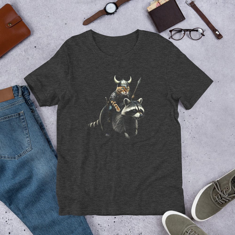 A dark gray t-shirt featuring a detailed illustration of a Viking cat wearing a horned helmet and armor, holding a spear, and riding a fierce-looking raccoon. 