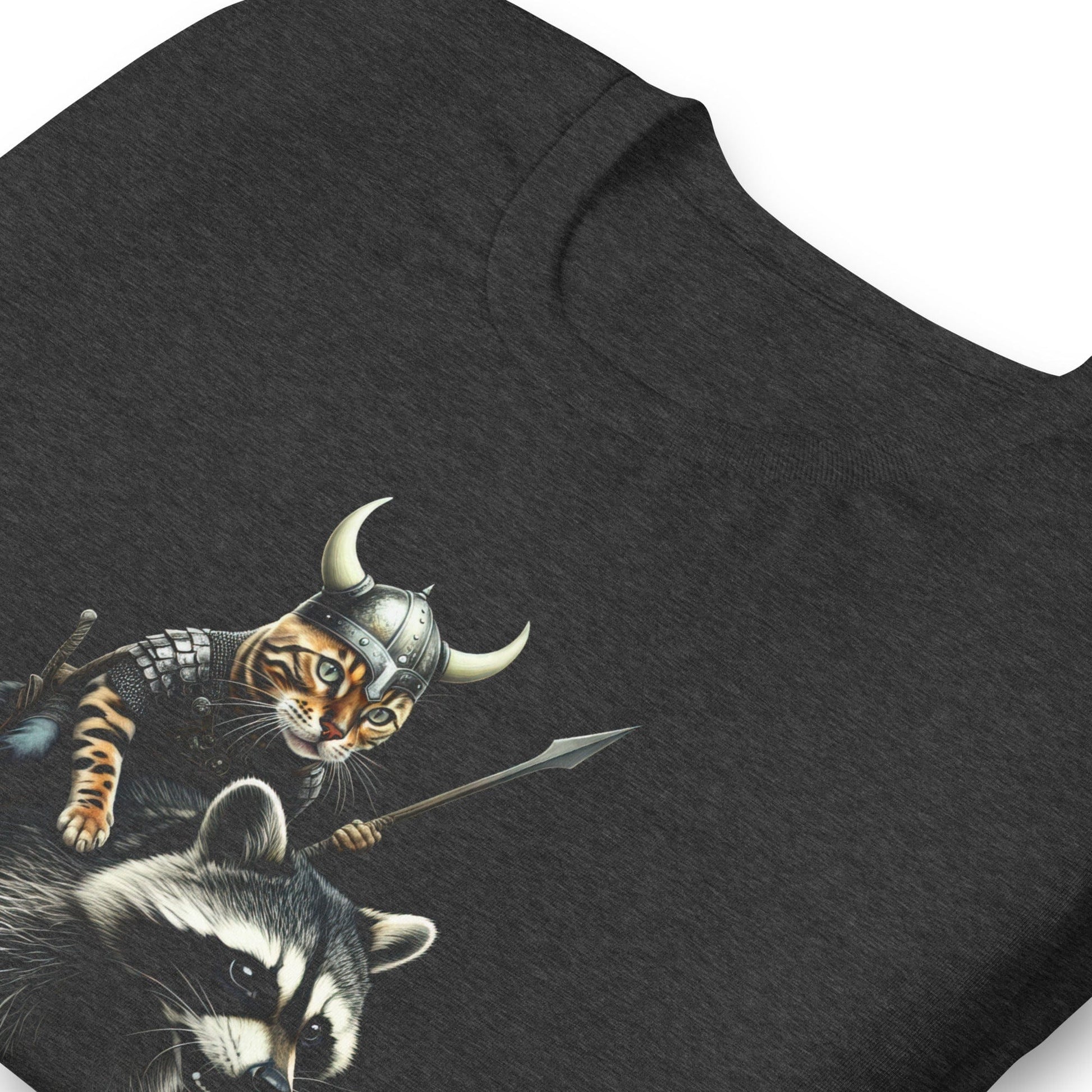 A dark gray t-shirt featuring a detailed illustration of a Viking cat wearing a horned helmet and armor, holding a spear, and riding a fierce-looking raccoon. 