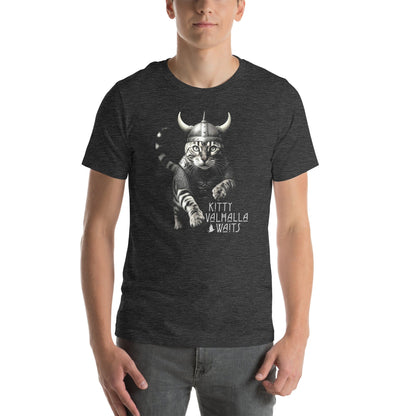 A male model wearing a dark gray t-shirt featuring a Viking-themed design of a fierce bengal cat wearing a horned helmet and armor. The text below reads 'Kitty Valhalla Waits' in bold, stylized font. 