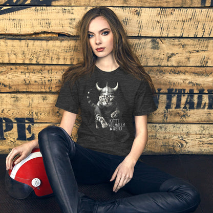 A female model wearing a dark gray t-shirt featuring a Viking-themed design of a fierce bengal cat wearing a horned helmet and armor. The text below reads 'Kitty Valhalla Waits' in bold, stylized font. 