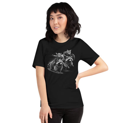 Woman wearing black t-shirt featuring two Viking cats wearing armor and helmets, riding armored raccoons. One cat holds a sword, and the other carries a shield. The design is detailed with dynamic movement and intricate linework.