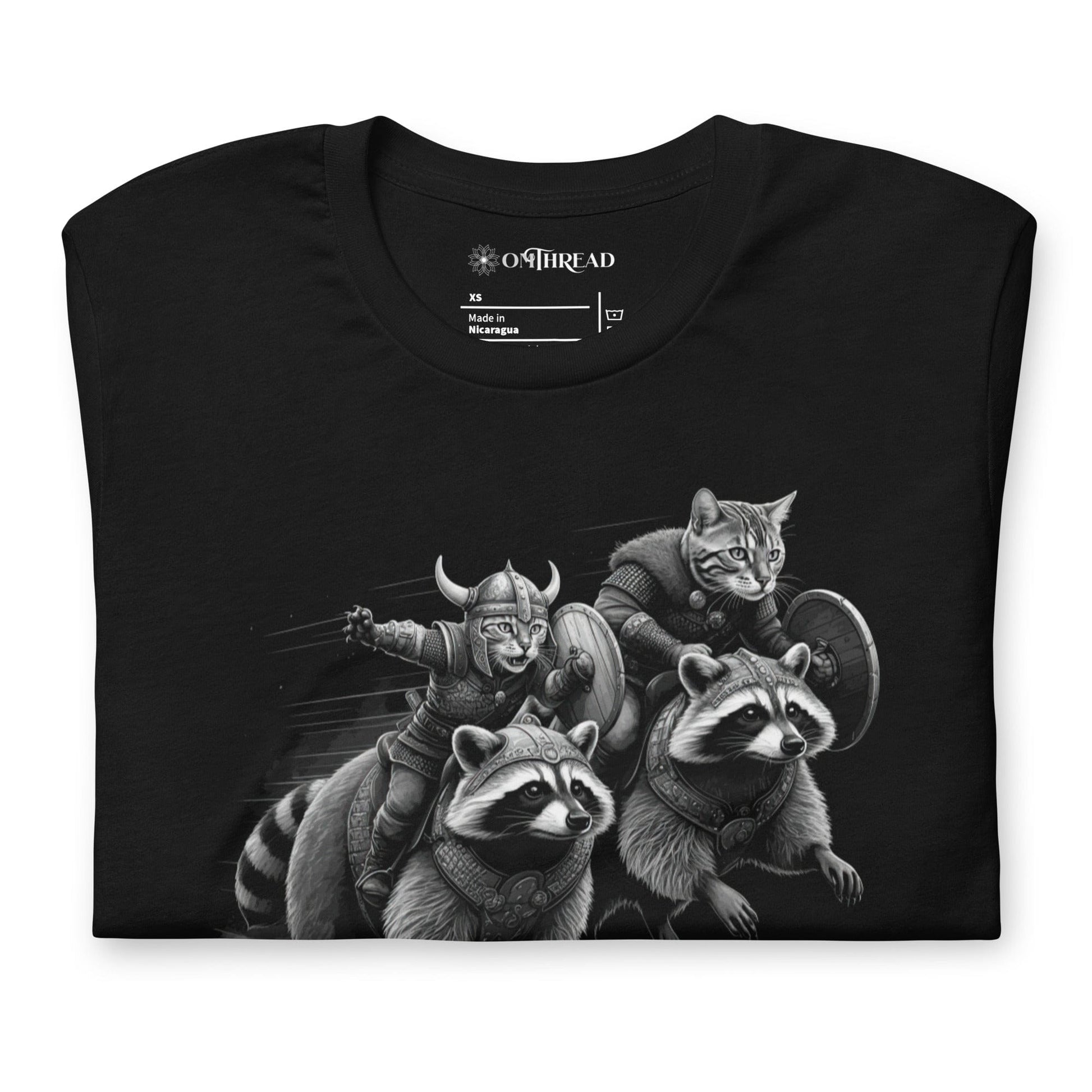 Black t-shirt featuring two Viking cats wearing armor and helmets, riding armored raccoons. One cat holds a sword, and the other carries a shield. The design is detailed with dynamic movement and intricate linework.