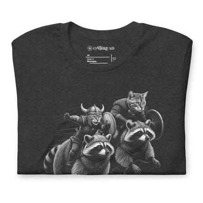 Dark gray t-shirt featuring two Viking cats wearing armor and helmets, riding armored raccoons. One cat holds a sword, and the other carries a shield. The design is detailed with dynamic movement and intricate linework.