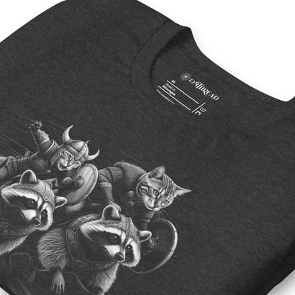 Dark gray t-shirt featuring two Viking cats wearing armor and helmets, riding armored raccoons. One cat holds a sword, and the other carries a shield. The design is detailed with dynamic movement and intricate linework.